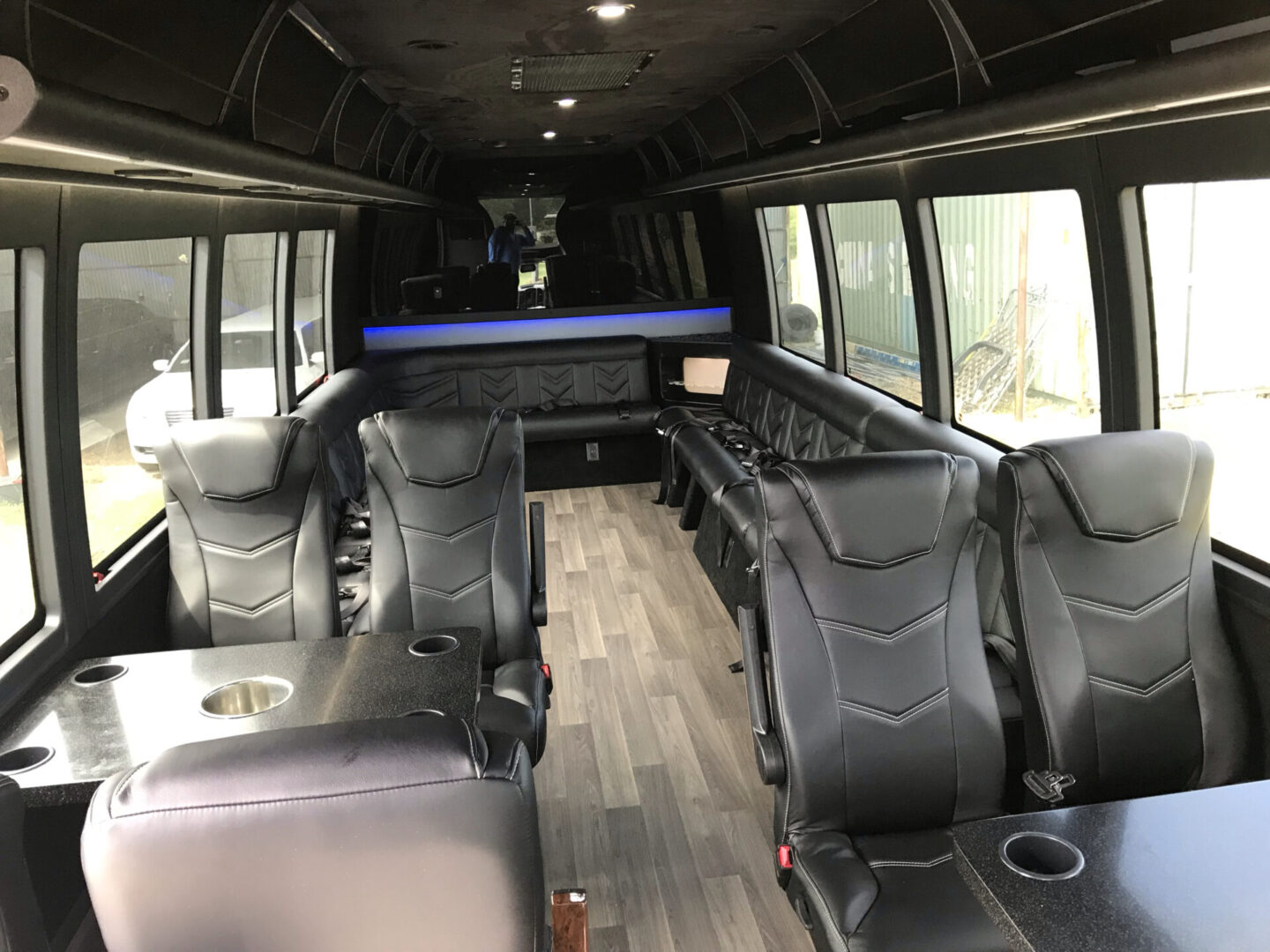 Black leather seats inside a party bus.